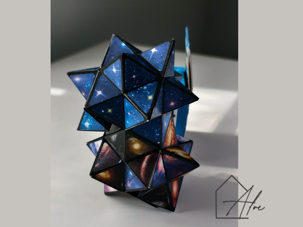 Space puzzle cube partially unfolded showing planet and galaxy artwork with packaging box behind