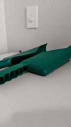 Plastic gutter scoop in use – clearing leaves from roof gutter