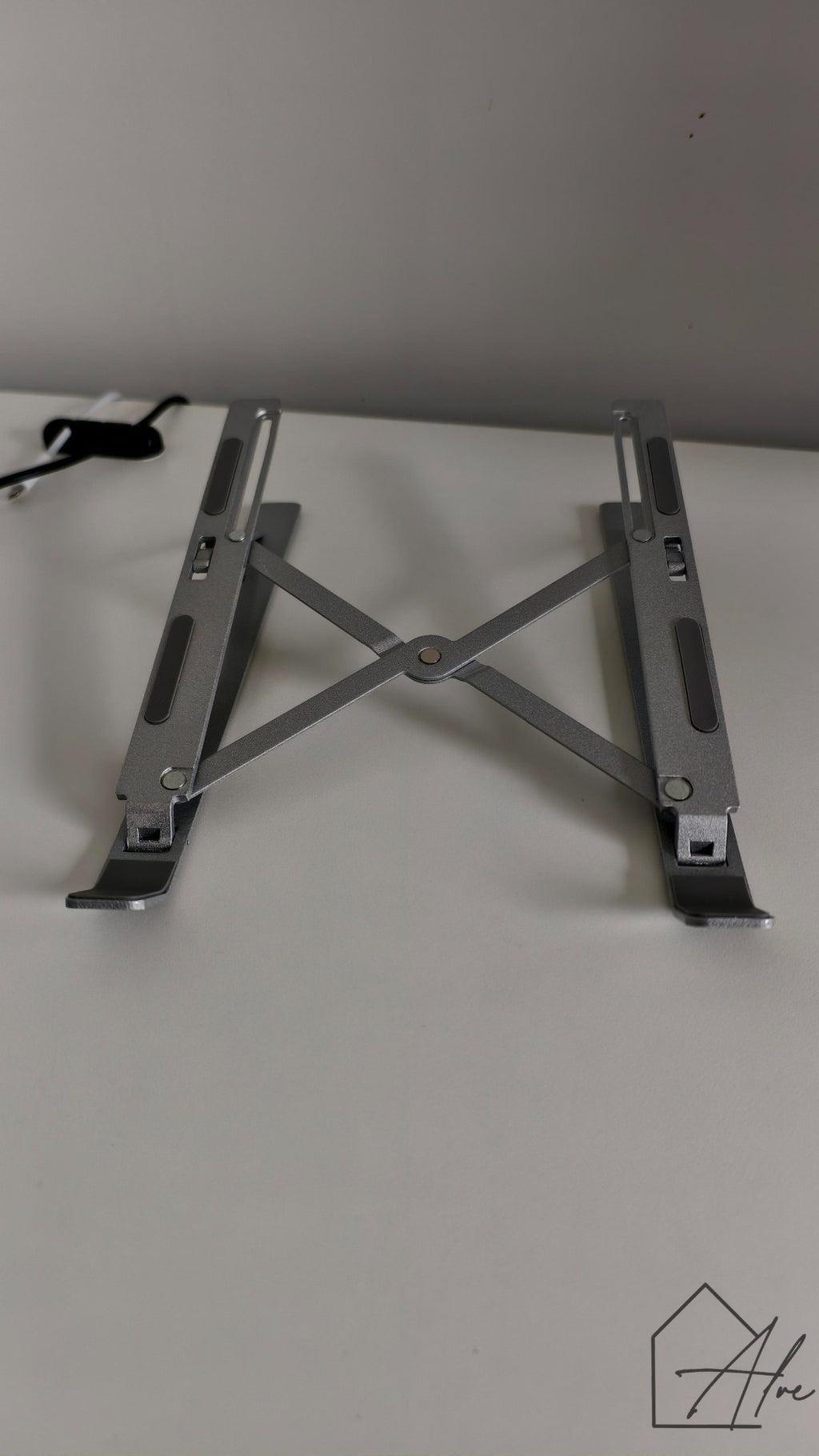 Foldable laptop riser in use – raises screen to ergonomic eye level