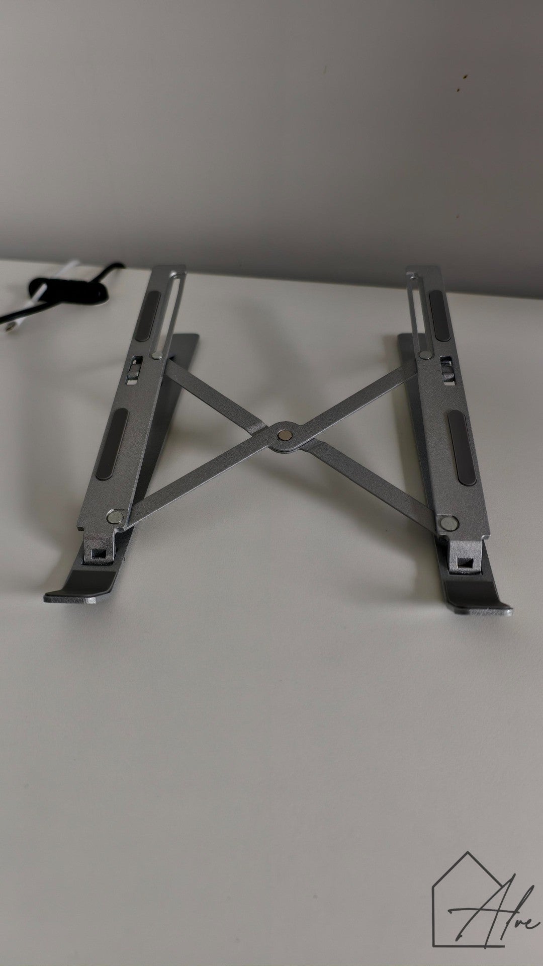 Foldable laptop riser in use – raises screen to ergonomic eye level