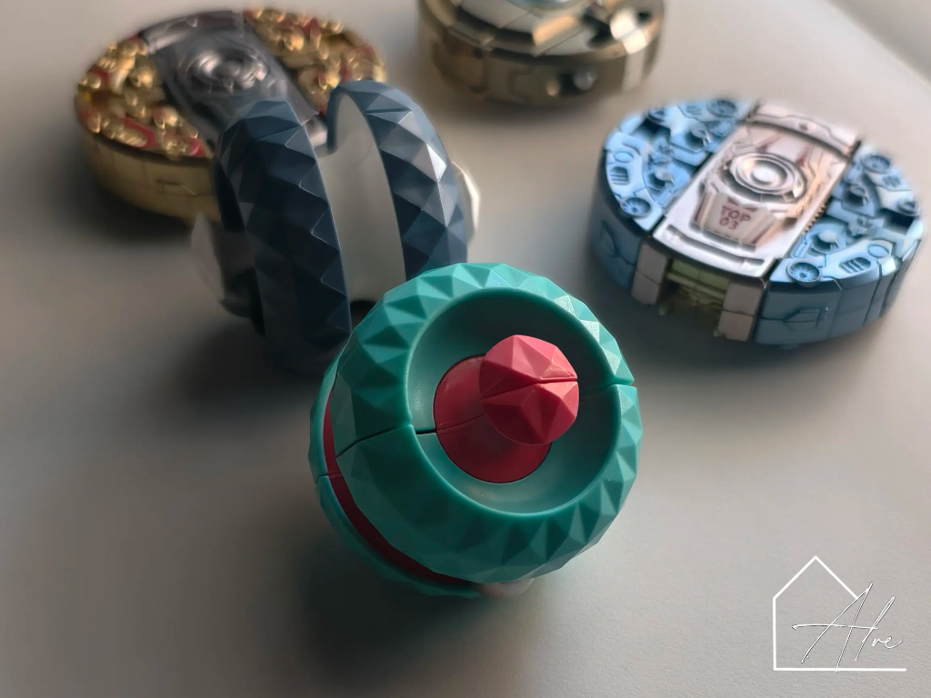 Teal and red sphere fidget ball with the halves rotated to show the internal track
