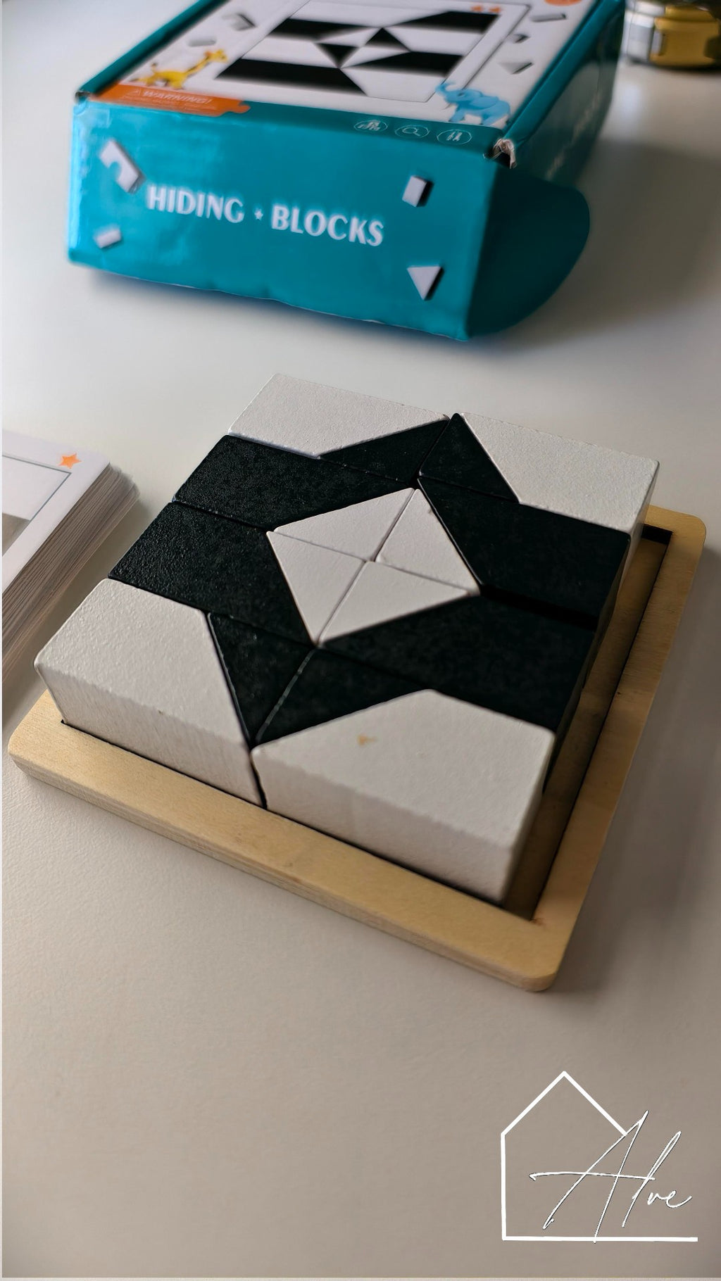 Montessori tangram puzzle close-up – smooth wooden pieces ages 3+