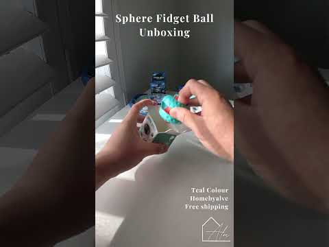 Hands playing with the sphere fidget ball, rotating and twirling the two halves