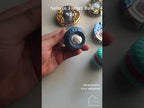 Sphere fidget ball being twisted and rotated in hand, showing the steel beads moving through the internal track